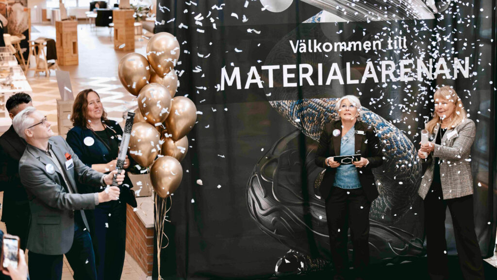Materialarenen is visible on a sign in the background. In the foreground are confetti and people celebrating.